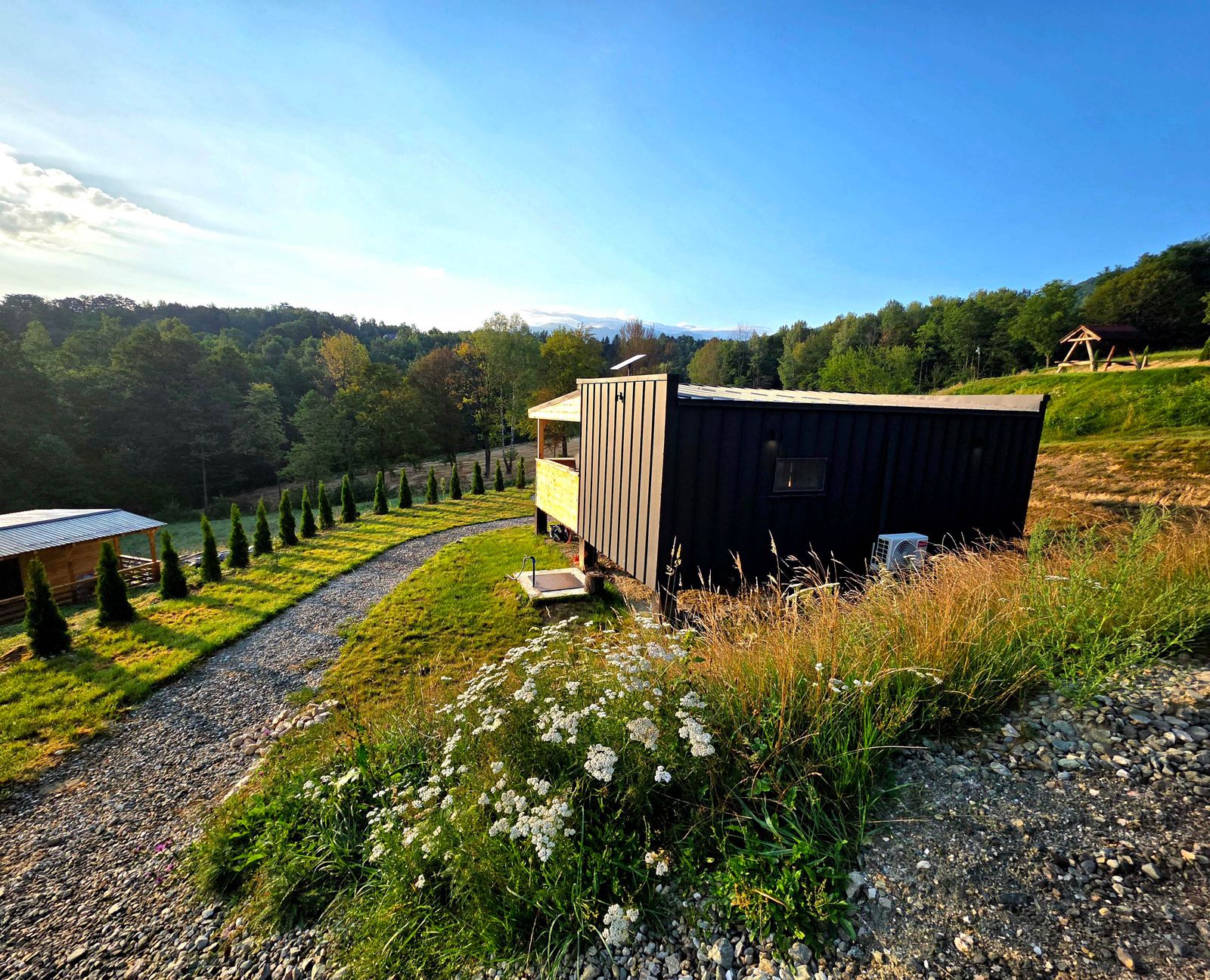 Side exterior view of the cabin highlighting the wooden construction and covered terrace