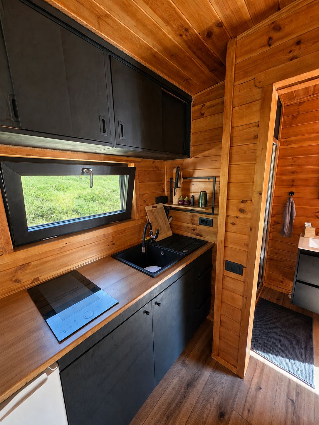 The kitchenette, with a window over the sink looking straight onto the meadow
